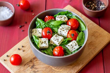 Salad with tomatoes, spinach and cheese. Italian cuisine. Healthy eating. Dietの写真素材