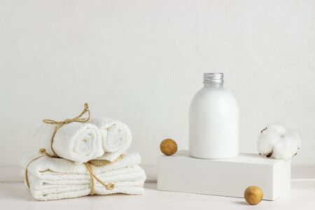 Cosmetics and towels on a white background. Design. Minimal concept. Spa. Skin care products. Copy space. Mock-up.の写真素材