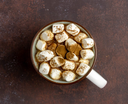 Hot chocolate with marshmallows in a white mug on a rusty background. Winter. Recipes. Hot drink....