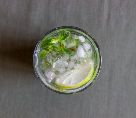 Cocktail mojito with lime, mint and ice. Recipe. Alcohol. Summer drink. Vegetarianism Health