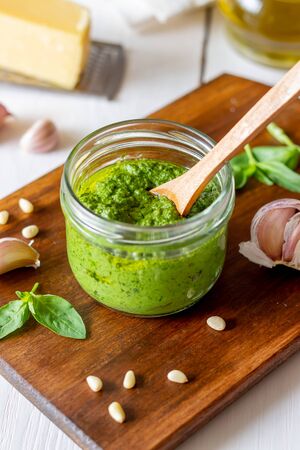 Italian pesto sauce on a wooden background. National kitchen. Healthy eating. Vegetarian food. Recipeの写真素材