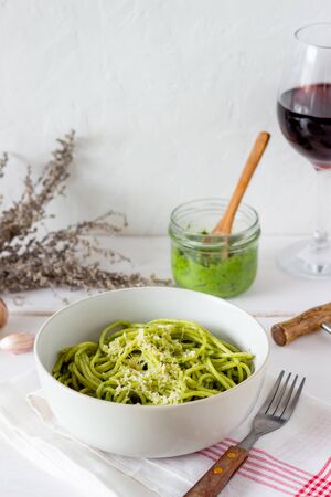 Pasta spaghetti with pesto sauce on a wooden background. National kitchen. Healthy eating. Vegetarian food. Recipeの写真素材