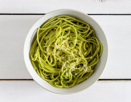 Pasta spaghetti with pesto sauce on a wooden background. National kitchen. Healthy eating. Vegetarian food. Recipeの写真素材