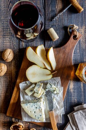 Cheese platter with blue cheese and pear. Wine snack. Italian cuisine. Vegetarian food. Healthy eatingの写真素材