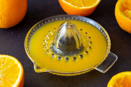 Freshly squeezed orange juice on a dark background. Healthy eating. Diet. Vegetarian foodの写真素材