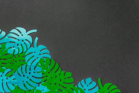 Paper palm leaves on a green background. Minimal concept. Flat lay. Copy space.