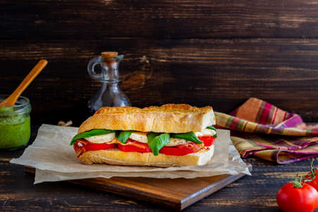 Caprese sandwich with tomatoes, mozzarella, basil and bacon. Healthy eating. Italian cuisine.の写真素材