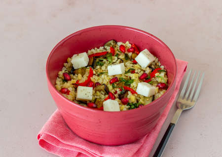 Bulgur with cheese, pepper, eggplant and pomegranate. Healthy eating. Vegetarian food Dietの写真素材