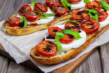 Bruschetta caprese with mozzarella, tomatoes and basil. Healthy eating. Vegetable foodの写真素材
