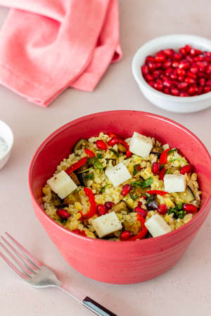 Bulgur with cheese, pepper, eggplant and pomegranate. Healthy eating. Vegetarian food Dietの写真素材