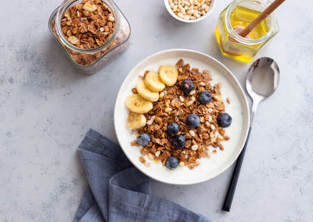 Granola with yogurt, blueberries, nuts, banana and honey. Muesli. Healthy eating. Vegetable foodの写真素材