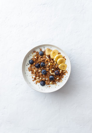 Granola with yogurt, blueberries, nuts, banana and honey. Muesli. Healthy eating. Vegetable food