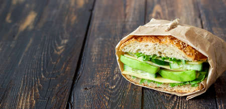 Sandwich with green salad, avocado, cucumber and cheese. Healthy eating. Vegetarian food. Breakfastの写真素材