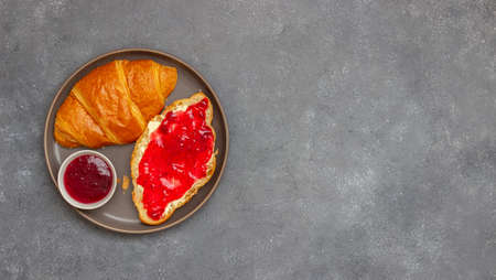 Croissant with cranberry jam and butter. Breakfast. Vegetarian food. Pastriesの写真素材