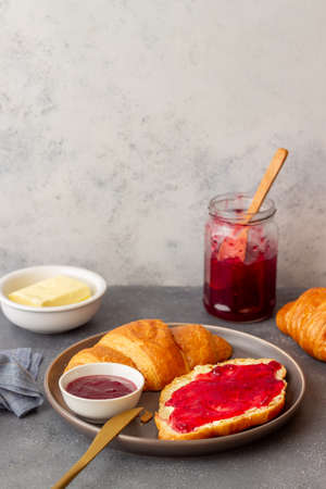 Croissant with cranberry jam and butter. Breakfast. Vegetarian food. Pastriesの写真素材