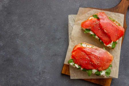 Open sandwiches with salmon, arugula and white cheese. Healthy eatingの写真素材