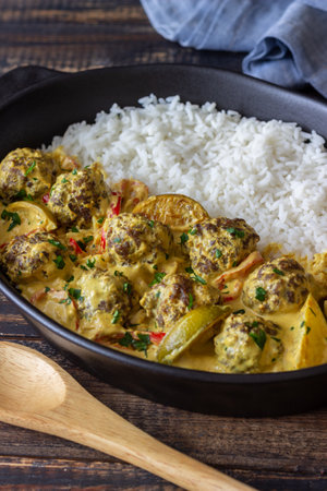 Meatballs with rice, curry sauce, lime and red pepper. Healthy eatingの写真素材