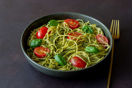 Pasta spaghetti with pesto sauce, tomatoes and basil. Healthy eating. Vegetable foodの写真素材