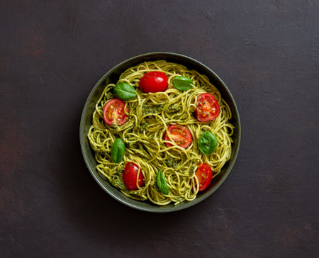 Pasta spaghetti with pesto sauce, tomatoes and basil. Healthy eating. Vegetable food