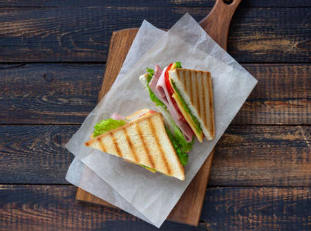 Sandwich with ham, salad, tomatoes and cheese. American cuisine. Fast foodの写真素材