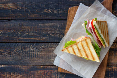 Sandwich with ham, salad, tomatoes and cheese. American cuisine. Fast foodの写真素材