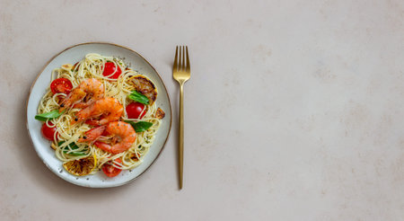 Pasta spaghetti with shrimp, tomatoes, garlic, spinach and lemon. Italian cuisine. Seafood diet
