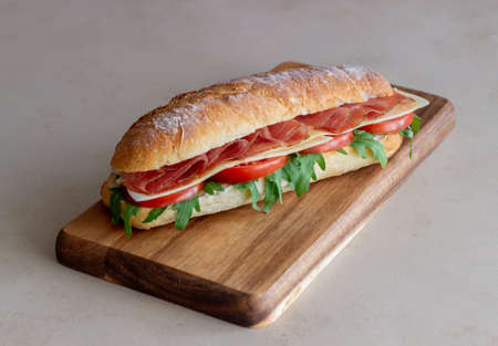 Sandwich with prosciutto, tomatoes, arugula and cheese. Healthy eating Dietの写真素材