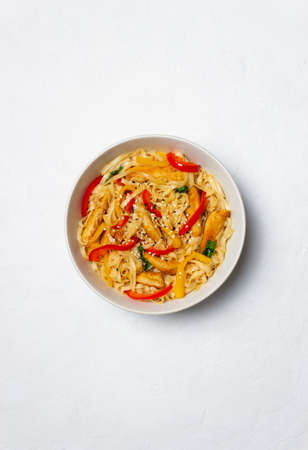 Udon noodles with chicken, pepper and sesame. Chinese foodの写真素材