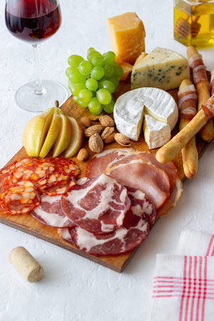 wine snack. Jamon, camembert, chorizo, almonds blue cheese parmesan Antipasti Wine appetizer