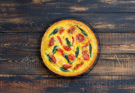 Quiche or pie with tomatoes, spinach and cheese. Healthy eating. Vegetarian food. French cuisine