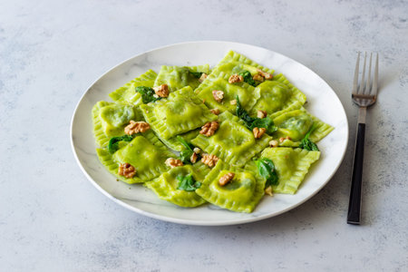 Green ravioli with ricotta cheese, spinach and nuts. Healthy eating. Vegetarian food. Italian cuisineの写真素材