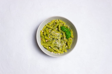Fusilli pasta with pesto sauce, cheese and nuts. healthy eating. Vegetarian food. Italian food