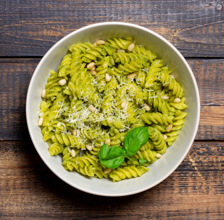 Fusilli pasta with pesto sauce, cheese and nuts. healthy eating. Vegetarian food. Italian food