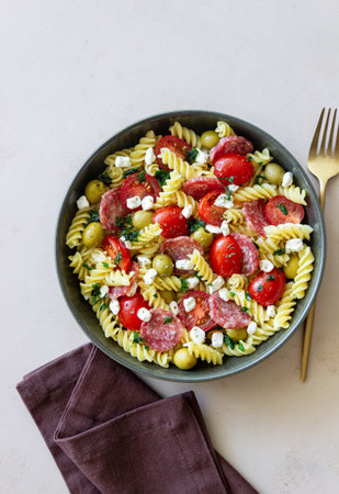 Salad with fusilli pasta, sausage, olives and cottage cheese. Italian foodの写真素材