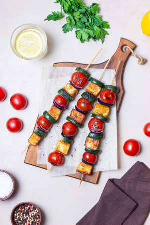Grilled skewers with halloumi cheese, zucchini, tomatoes and onions. Kebab. healthy eating. Vegetarian foodの写真素材