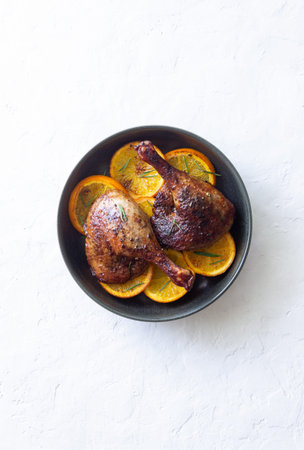 Baked duck legs with oranges and rosemary. rustic style