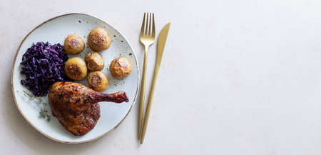 Baked duck leg with potatoes and red cabbageの写真素材