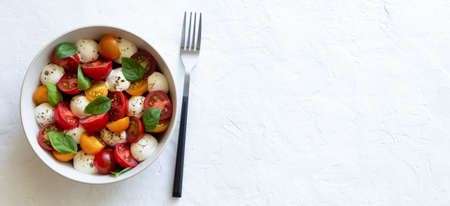 Salad with mozzarella, tomatoes and basil. healthy eating. Vegetarian foodの写真素材