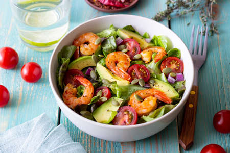Salad with shrimps, avocado, tomatoes, onions and seeds. healthy eating.の写真素材