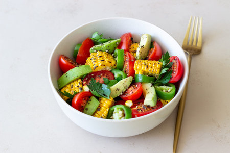 Salad with corn, avocado, tomatoes, peppers and parsley. healthy eating.