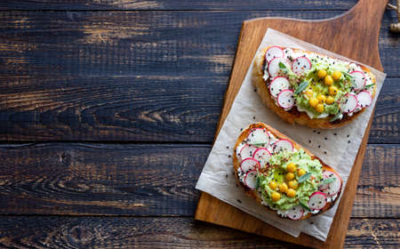 Bruschetta with guacamole, radish, white cheese, chickpeas and sage. Vegetarian food. Sandwich. Italian foodの写真素材