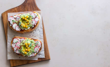 Bruschetta with guacamole, radish, white cheese, chickpeas and sage. Vegetarian food. Sandwich. Italian foodの写真素材