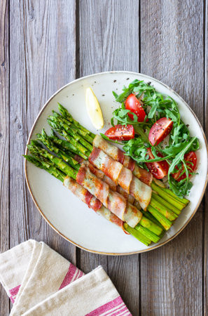 Asparagus baked with bacon and arugula and tomato salad. healthy eating. Dietの写真素材