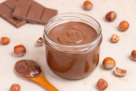 Chocolate paste with nuts in a jar. Dessert. Vegetarian foodの写真素材