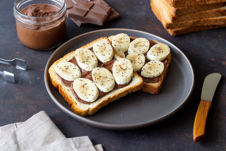 Sandwich with chocolate paste, banana and chia seeds. Breakfast. Vegetarian foodの写真素材