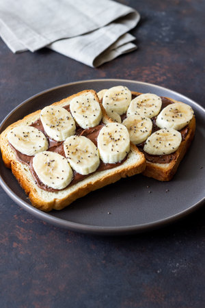 Sandwich with chocolate paste, banana and chia seeds. Breakfast. Vegetarian foodの写真素材
