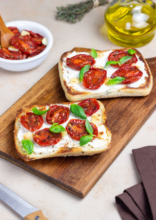Ciabatta with sun-dried tomatoes, white cheese and basil. Italian food. Vegetarian foodの写真素材