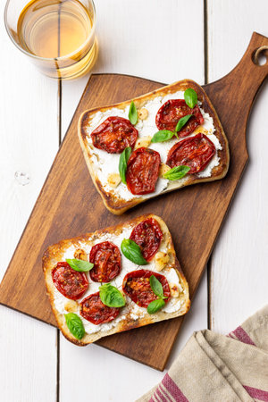 Ciabatta with sun-dried tomatoes, white cheese and basil. Italian food. Vegetarian foodの写真素材