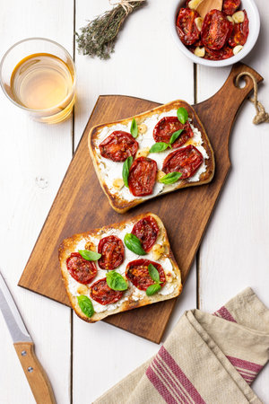 Ciabatta with sun-dried tomatoes, white cheese and basil. Italian food. Vegetarian foodの写真素材