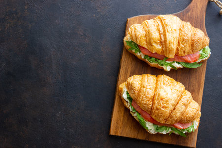 Croissants with salmon, white cheese and arugula. Breakfastの写真素材